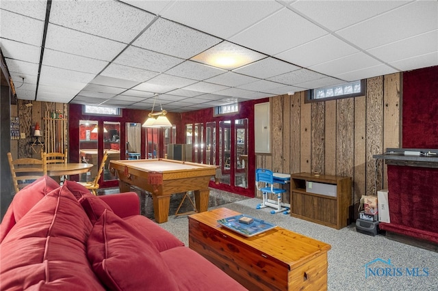 recreation room featuring a paneled ceiling, french doors, billiards, wooden walls, and carpet flooring