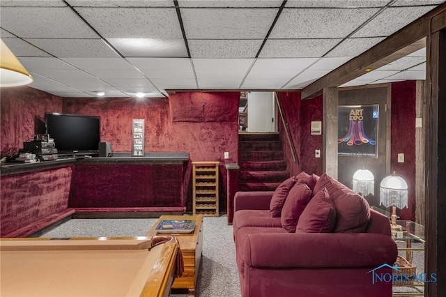 carpeted living room featuring a paneled ceiling