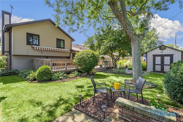 view of yard featuring a deck and a storage shed