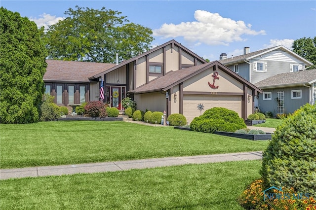 view of front of property with a front yard and a garage