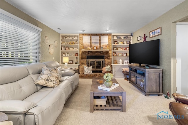 carpeted living room with built in features and a brick fireplace