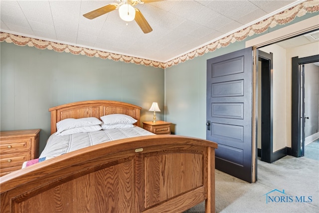 bedroom featuring ceiling fan and light carpet