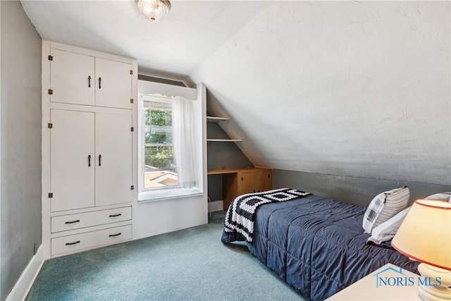 carpeted bedroom with lofted ceiling