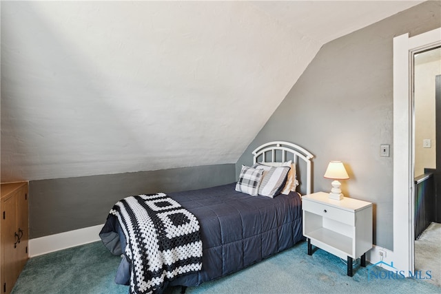 carpeted bedroom with vaulted ceiling