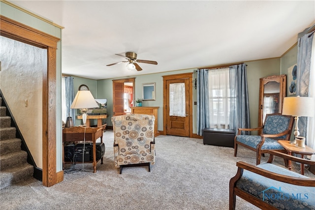 carpeted living room with ceiling fan