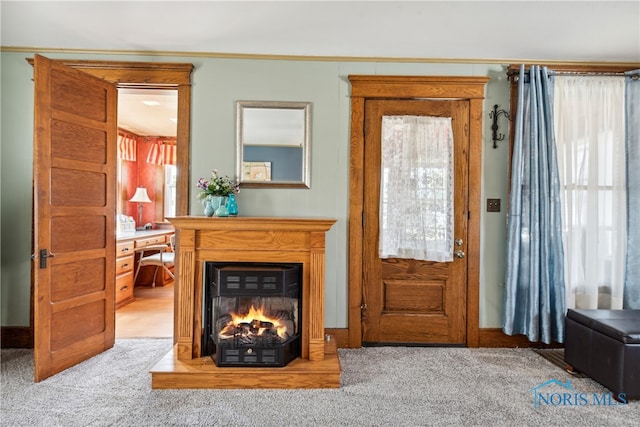 entrance foyer featuring carpet and ornamental molding