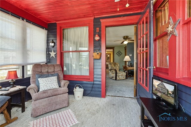 sitting room with ceiling fan and light carpet