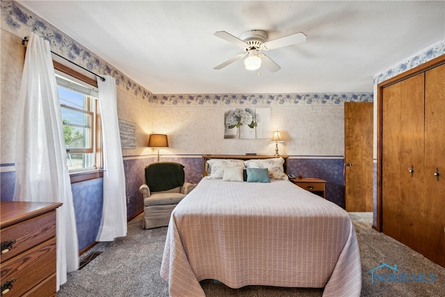 bedroom with carpet flooring, ceiling fan, and a closet