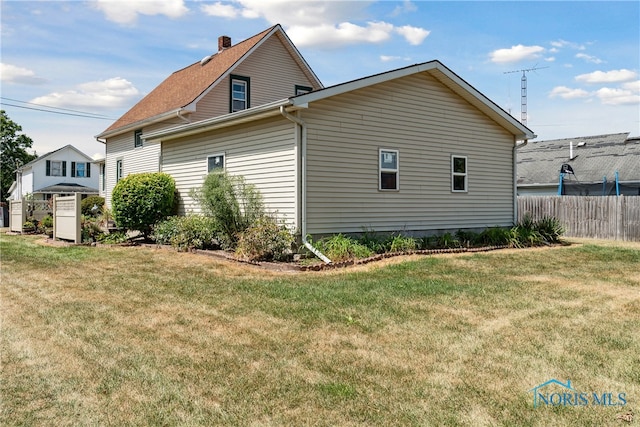 view of side of home featuring a lawn