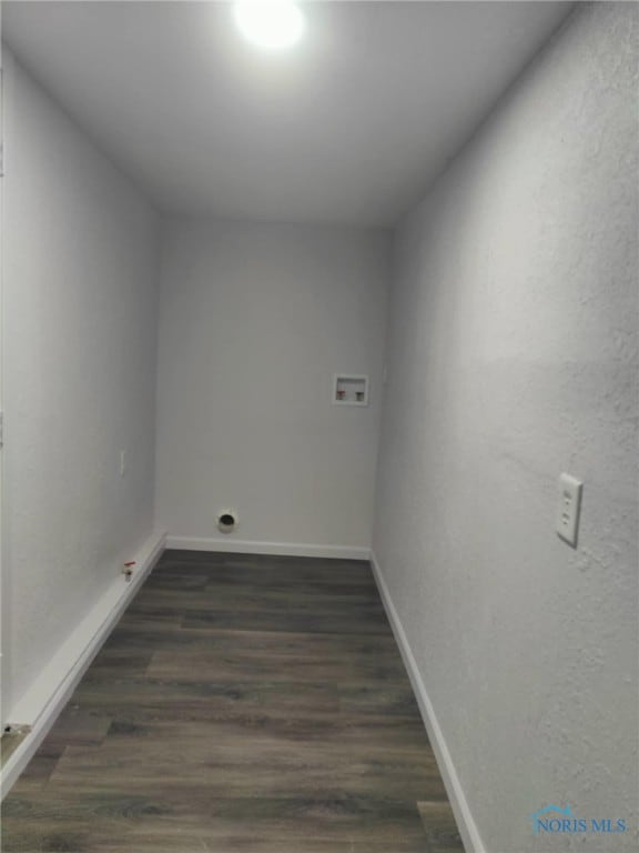 laundry area featuring washer hookup, laundry area, dark wood finished floors, and baseboards