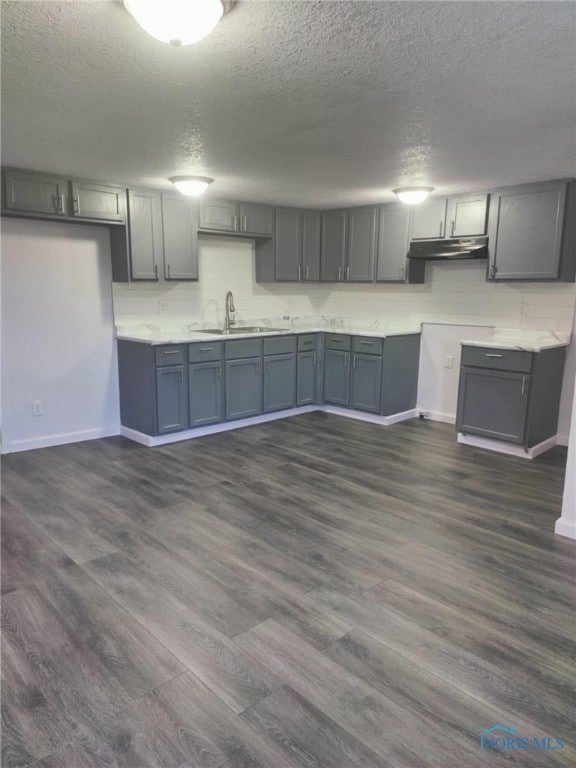 kitchen featuring gray cabinetry, sink, and dark hardwood / wood-style flooring