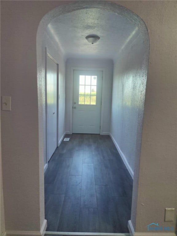 interior space with a textured ceiling and hardwood / wood-style flooring