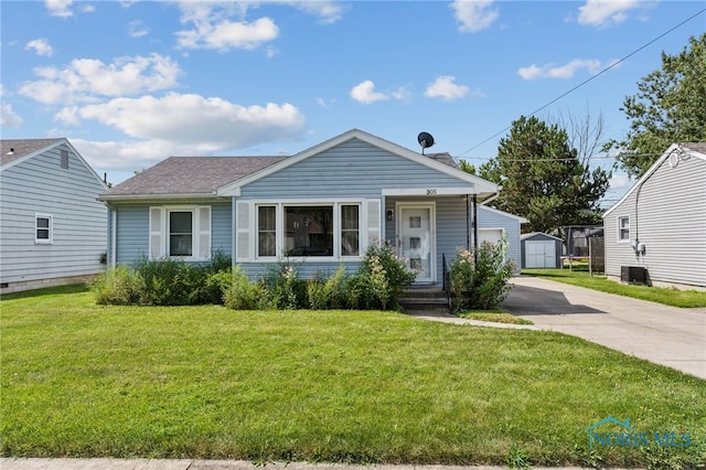 bungalow-style home with a shed and a front lawn