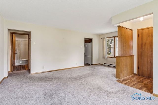 unfurnished living room with light carpet and a baseboard radiator