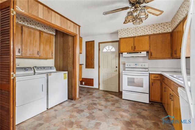 interior space with ceiling fan, white appliances, washing machine and dryer, and light tile patterned flooring