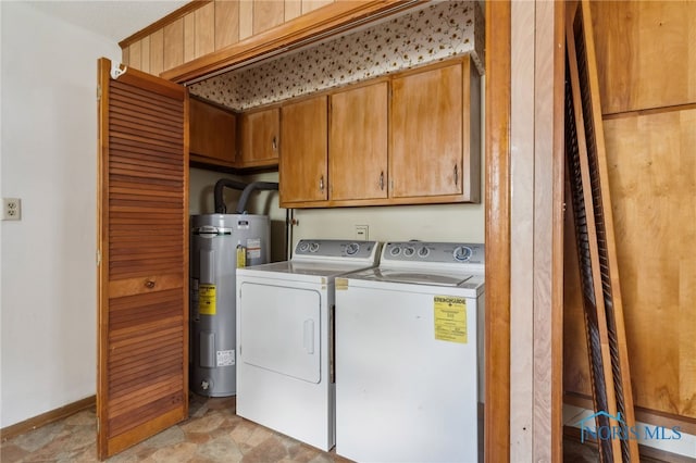 clothes washing area with electric water heater, cabinets, light tile patterned floors, and washer and dryer