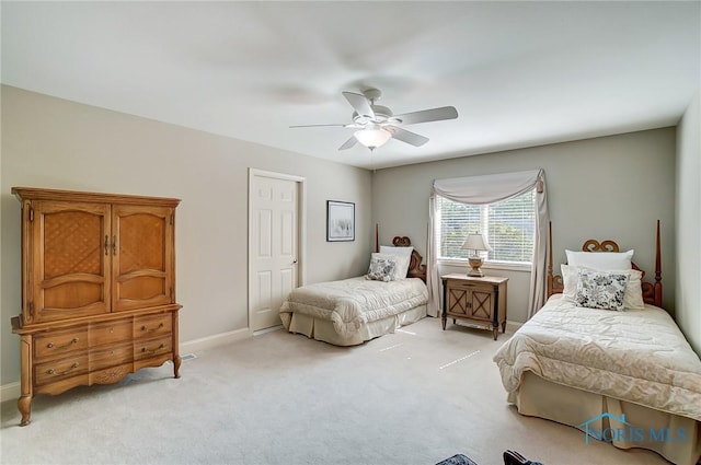 bedroom featuring light carpet, ceiling fan, and baseboards
