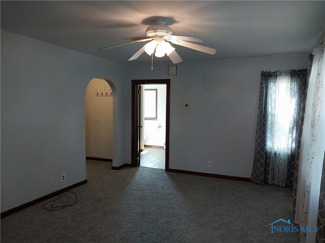 spare room with ceiling fan, carpet flooring, and a healthy amount of sunlight