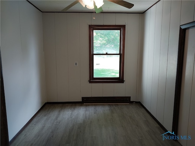 empty room with ceiling fan and wood-type flooring