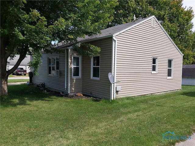 view of property exterior featuring a lawn