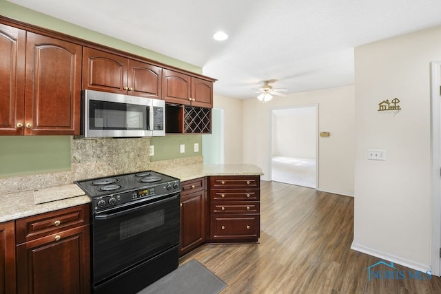 kitchen featuring dark wood-type flooring, decorative backsplash, light stone countertops, ceiling fan, and black electric range oven