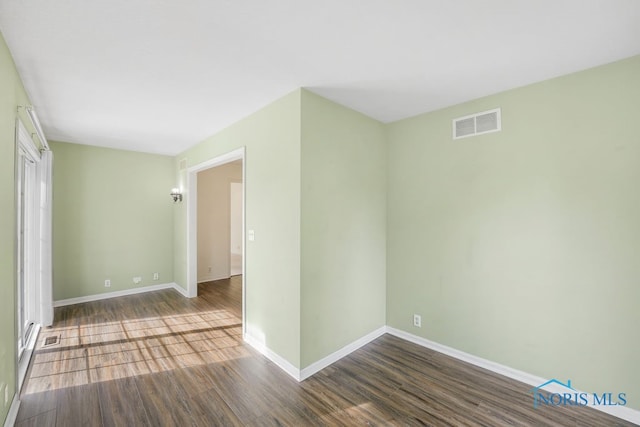 unfurnished room with wood-type flooring