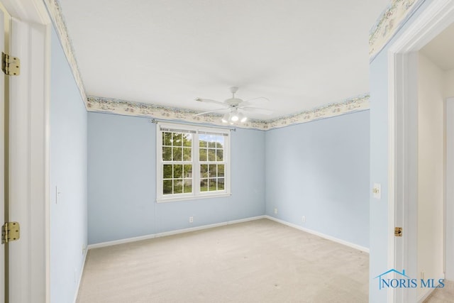 unfurnished room with ceiling fan and light colored carpet