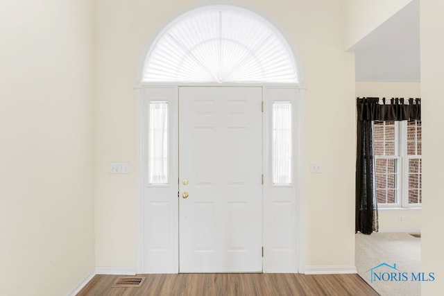 entryway with plenty of natural light and hardwood / wood-style floors