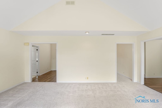 empty room featuring hardwood / wood-style floors and high vaulted ceiling