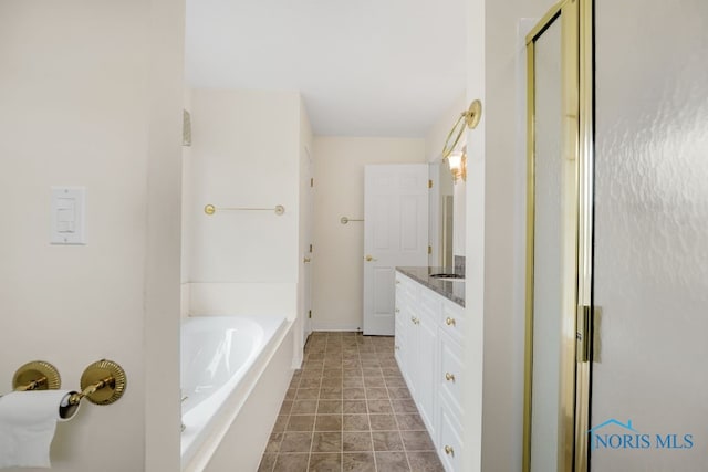 bathroom featuring tile patterned floors, independent shower and bath, and vanity