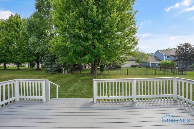 wooden terrace featuring a trampoline and a yard