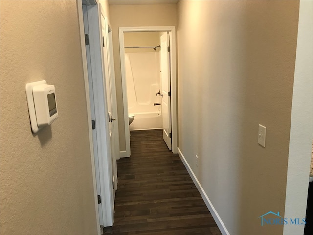 corridor featuring dark hardwood / wood-style floors