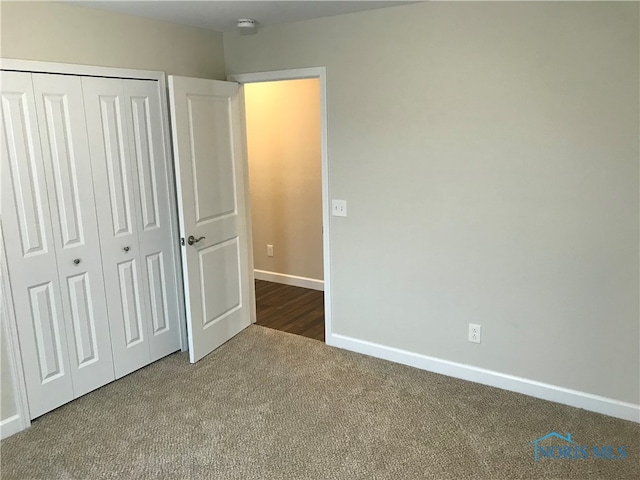 unfurnished bedroom featuring carpet floors and a closet