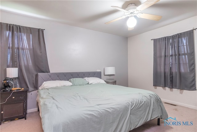 bedroom featuring ceiling fan and light colored carpet