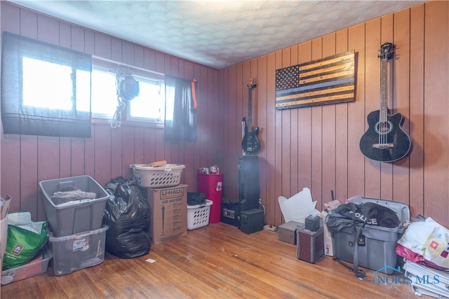 office area featuring hardwood / wood-style flooring and wooden walls