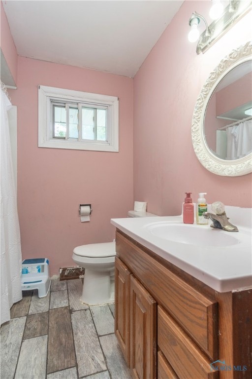 bathroom featuring tile patterned floors, vanity, and toilet