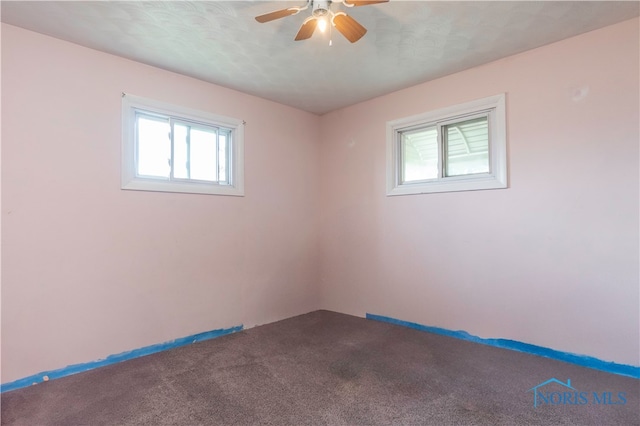 carpeted empty room featuring ceiling fan