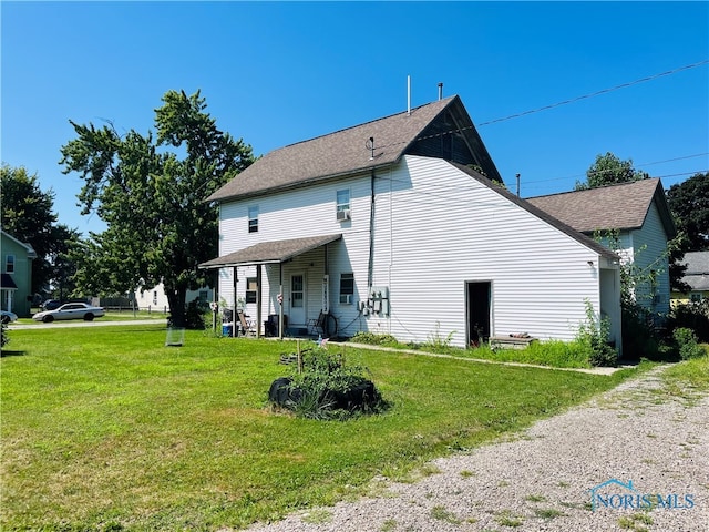 back of house with a yard