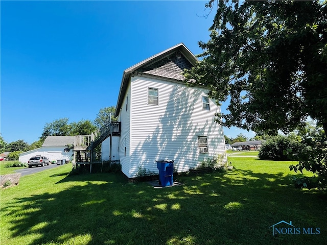 view of side of home with a lawn