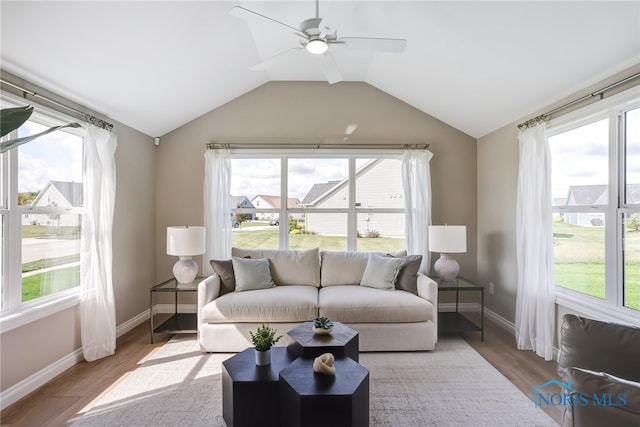 sunroom / solarium with a healthy amount of sunlight and ceiling fan