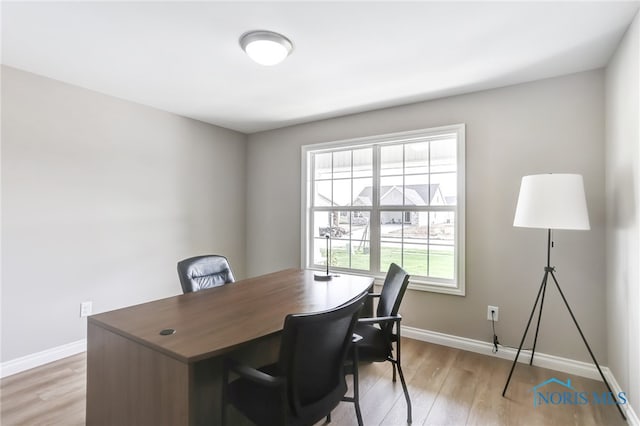 office with light wood-type flooring