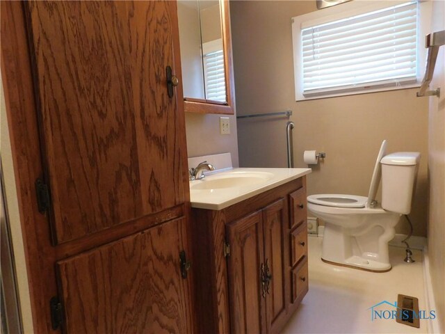 bathroom with toilet and vanity