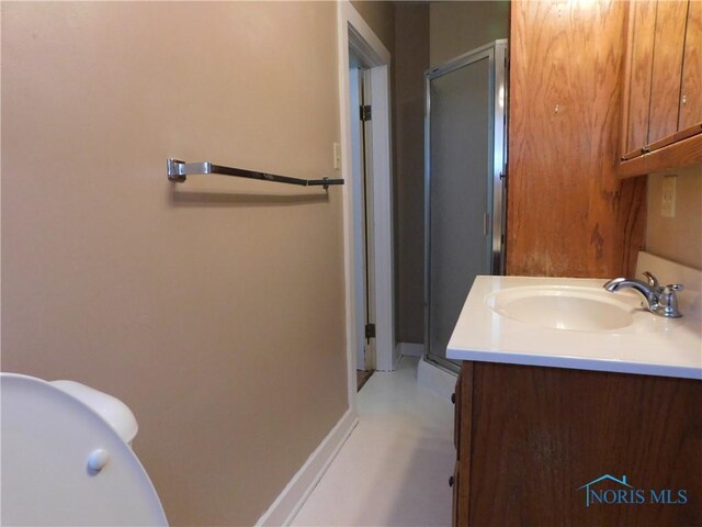 bathroom featuring vanity and a shower with shower door