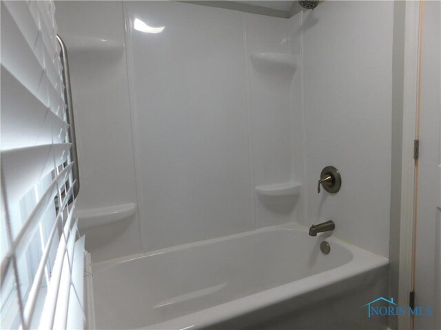 bathroom with bathing tub / shower combination