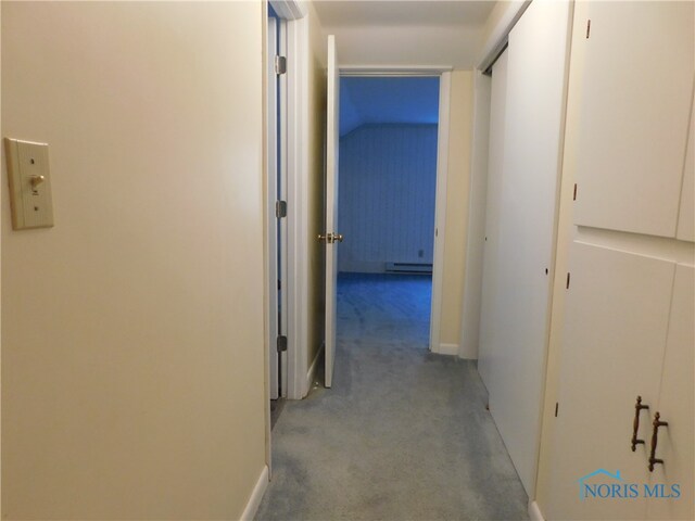 hallway featuring light colored carpet