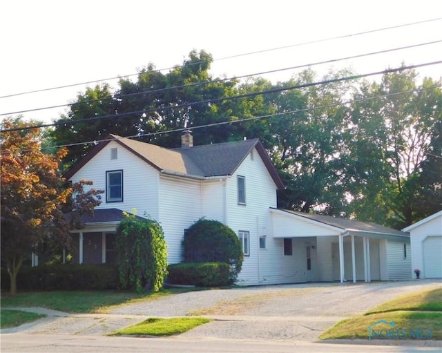 view of front of home with driveway and a chimney