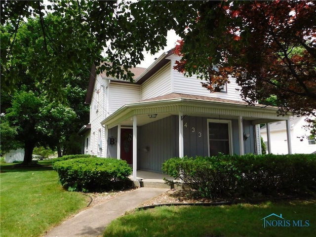 view of front of home featuring covered porch and a front lawn