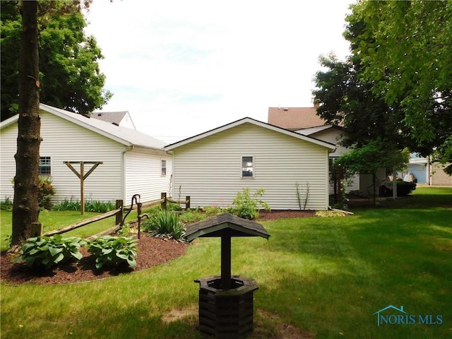 rear view of house featuring a yard