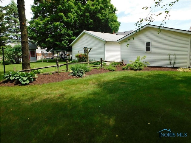 rear view of property with a yard