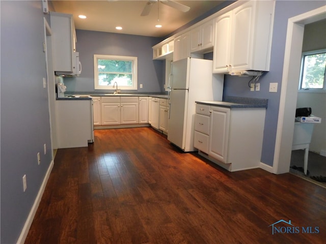 kitchen with ceiling fan, plenty of natural light, dark wood-type flooring, and white cabinetry